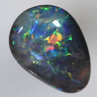 SOLID BLACK OPAL Bright red and orange sparkles over blue